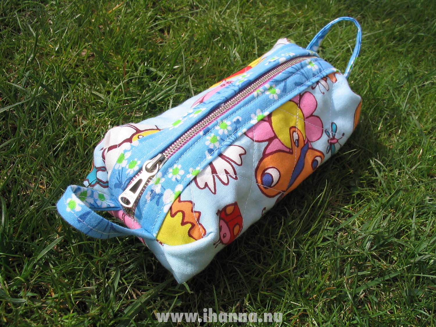 A blue pen case in butterfly and bugs patterned fabric, made by iHanna (Photo Copyright Hanna Andersson)