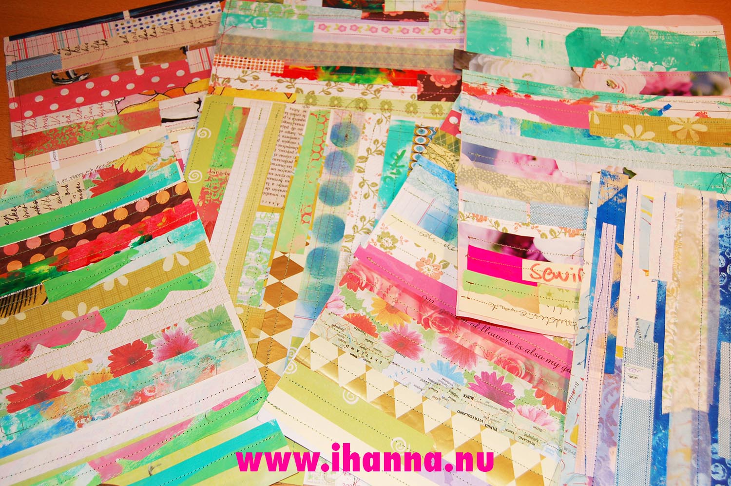 Colorful papers in a pile of iHannas sewn mixed media papers (Copyright Hanna Andersson)