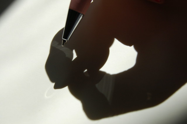 Hand and shadow hand writing in a diary (photo copyright Hanna Andersson)