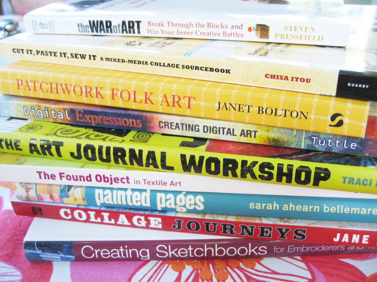 Fresh pile of creative books that I want to read all on painted pages folk art digital art mixed media and collage