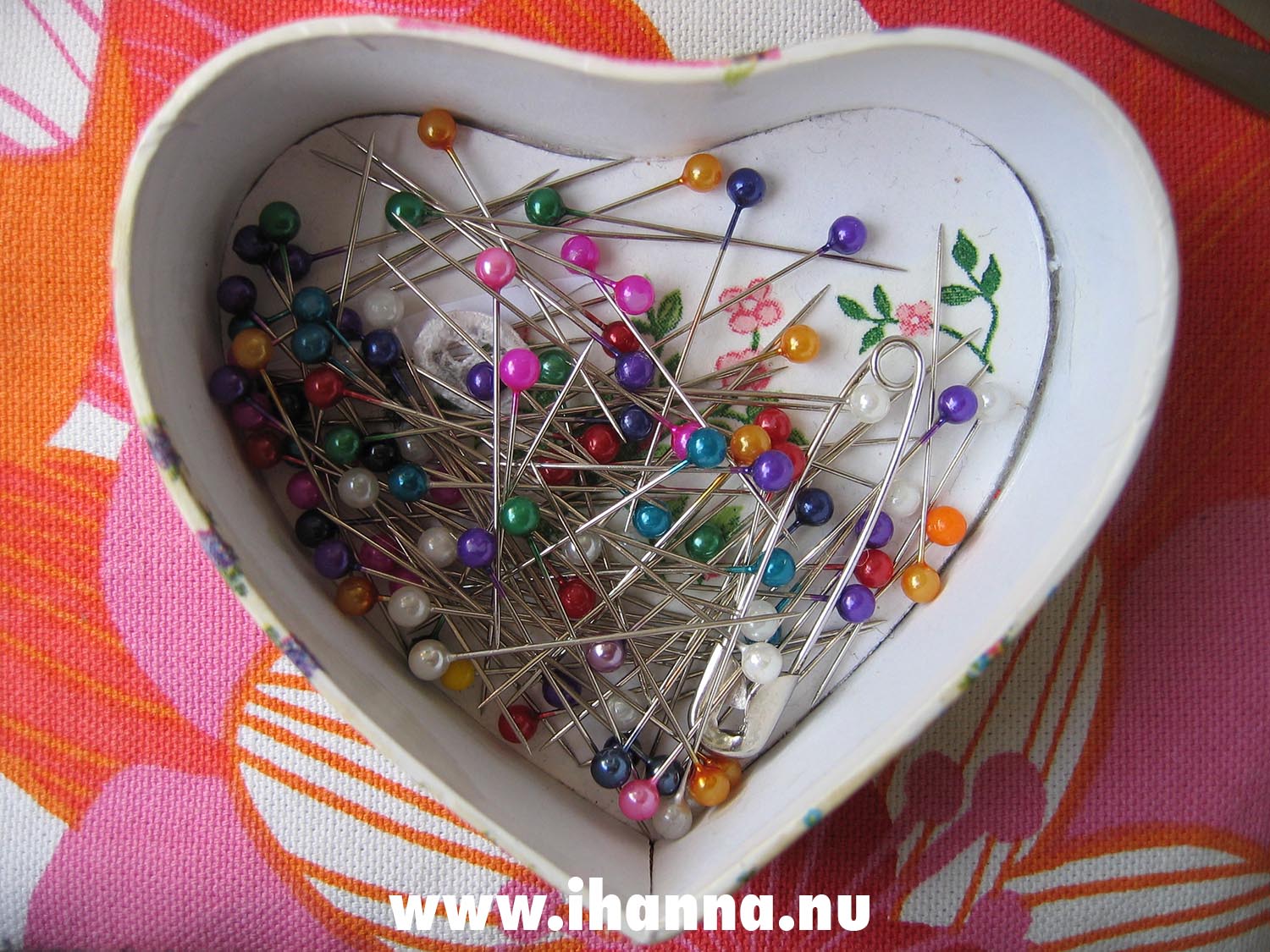 Sewing pins in heart shaped paper box on the sewing table (Photo copyright Hanna Andersson)