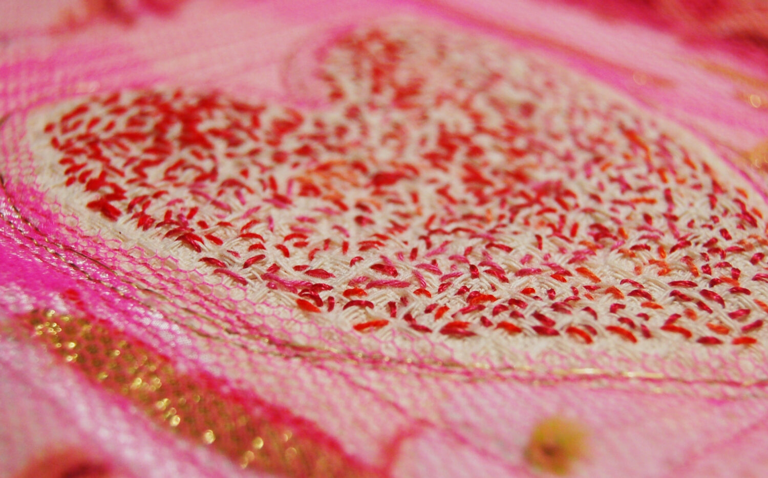 Close up detail of the art quilt Pink Sweet Heart Embroidery textile art piece with many many stitches by iHanna (Copyright Hanna Andersson)