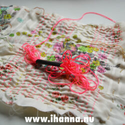 Stitching up-and-down stitches on cloth using neon thread (Photo copyright Hanna Andersson)