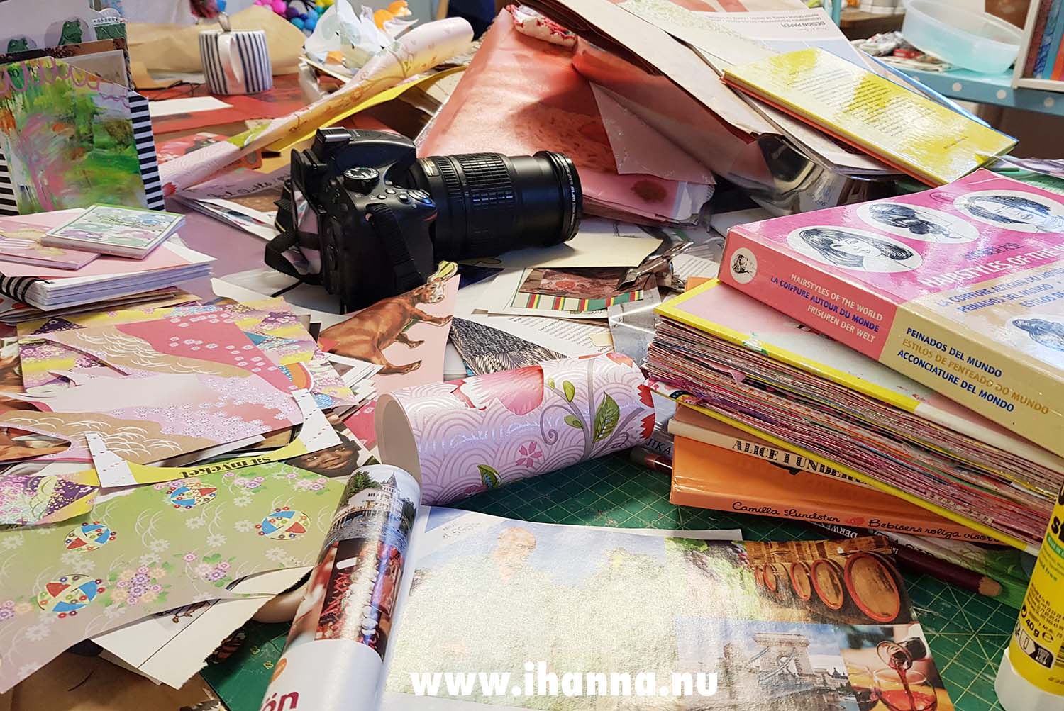 Messy desk in the studio when creating handmade postcards